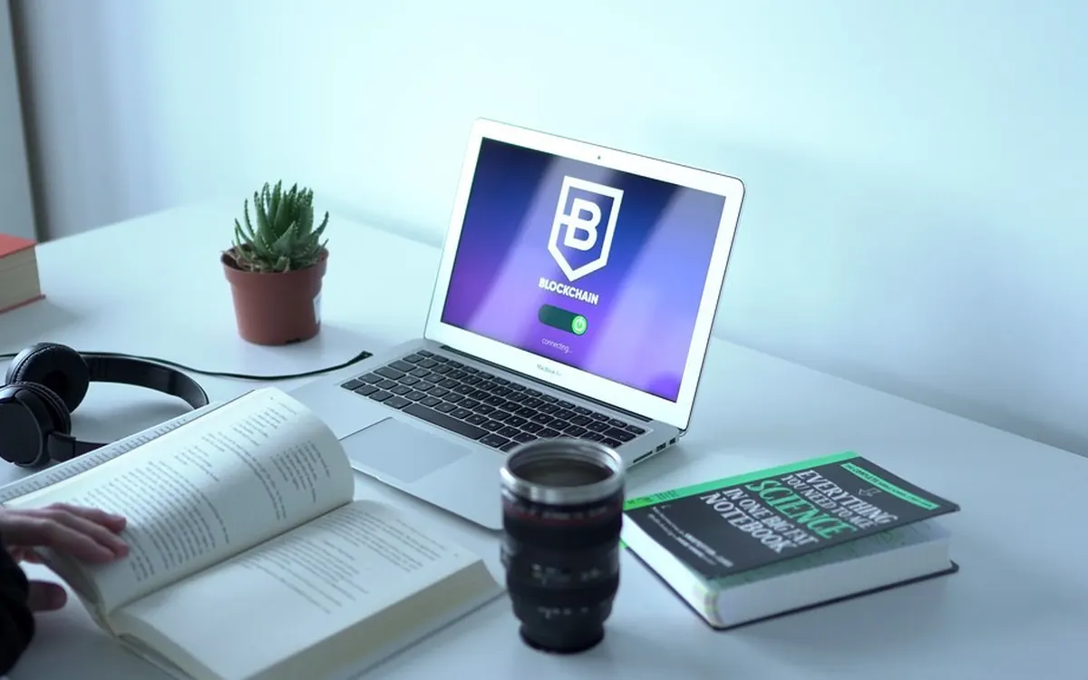 Study desk with a laptop, headphones and an open book
