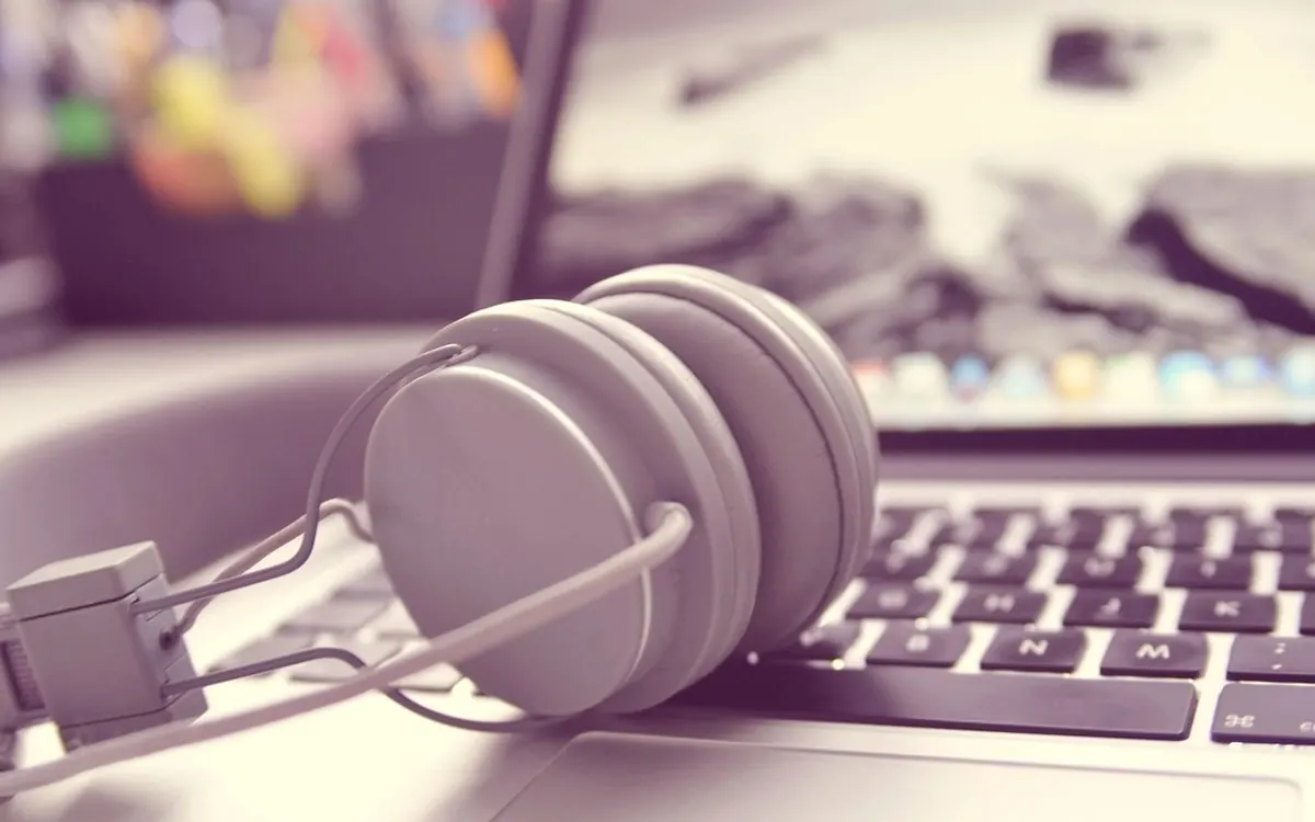 Headphones resting on a laptop keyboard