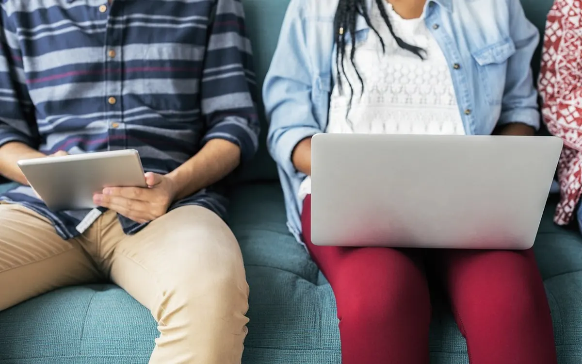 Learners sitting together with a laptop and a tablet